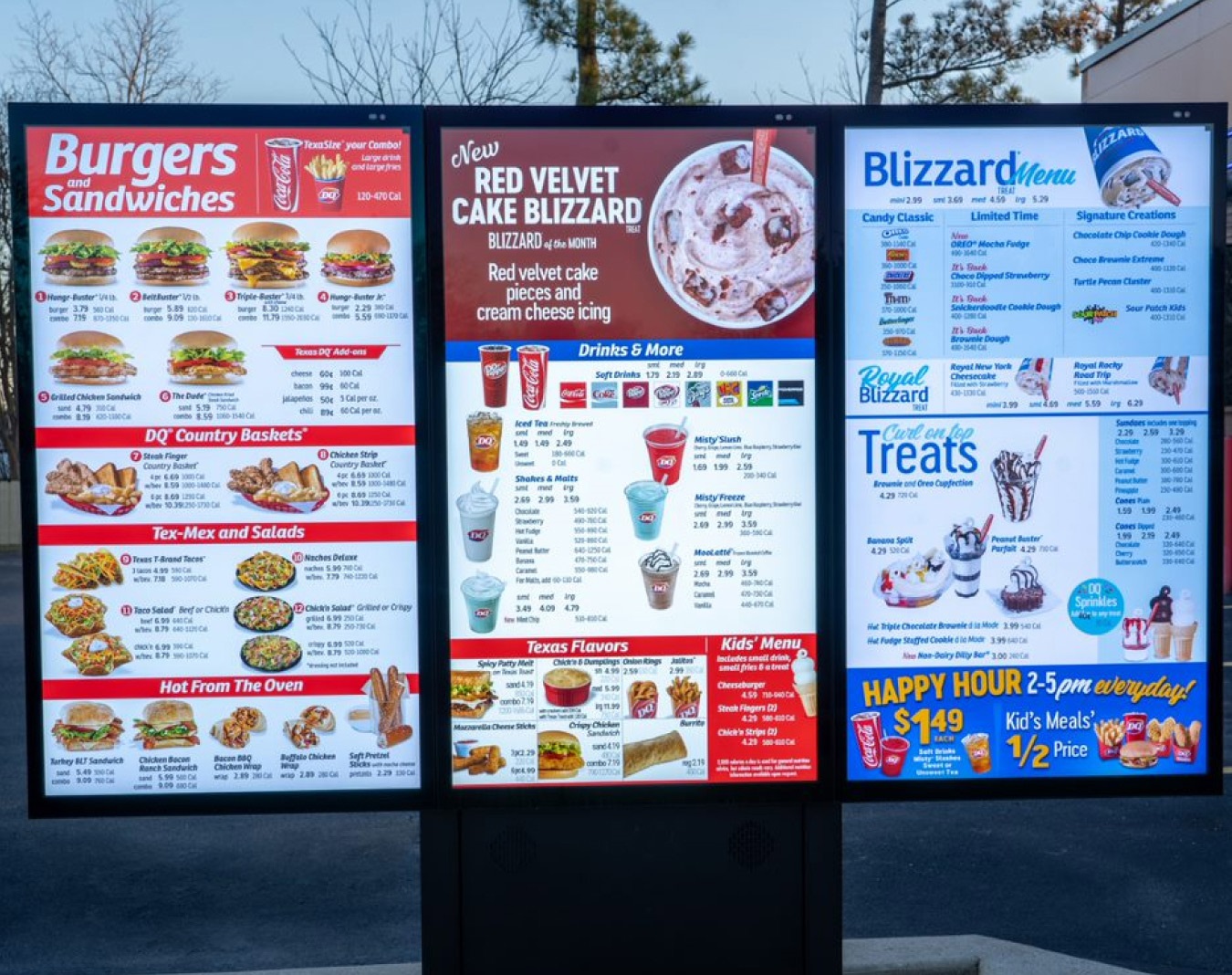 A large, full-size Dairy Queen outdoor drive-thru menu with three vertical panels. 							